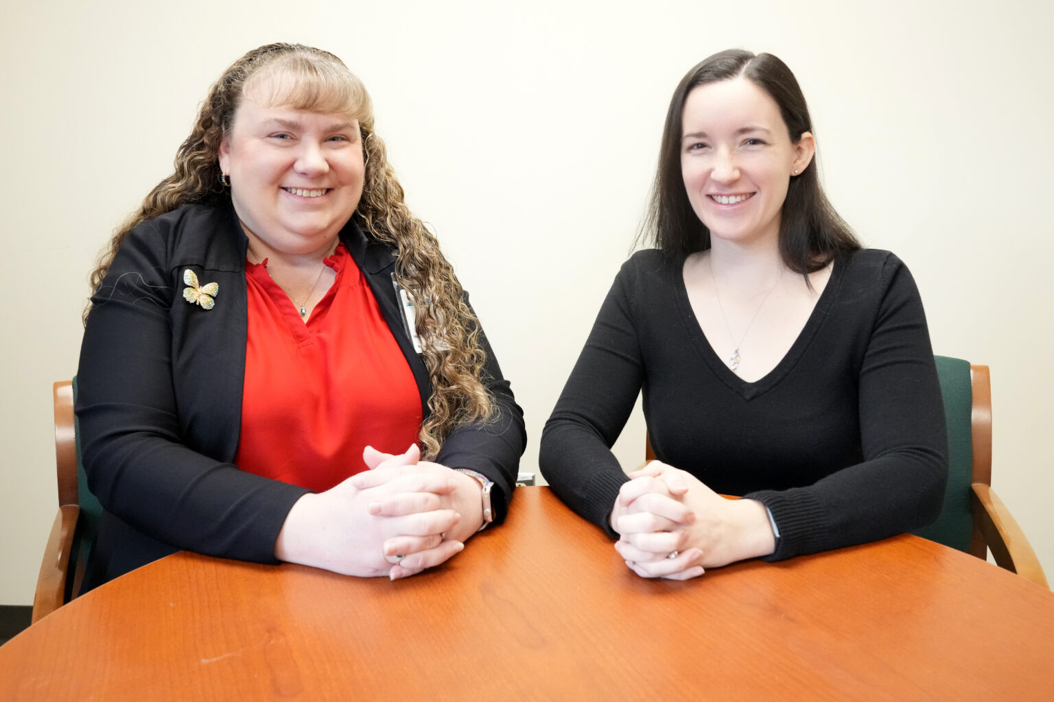 Two CVES staff members smiling at a table