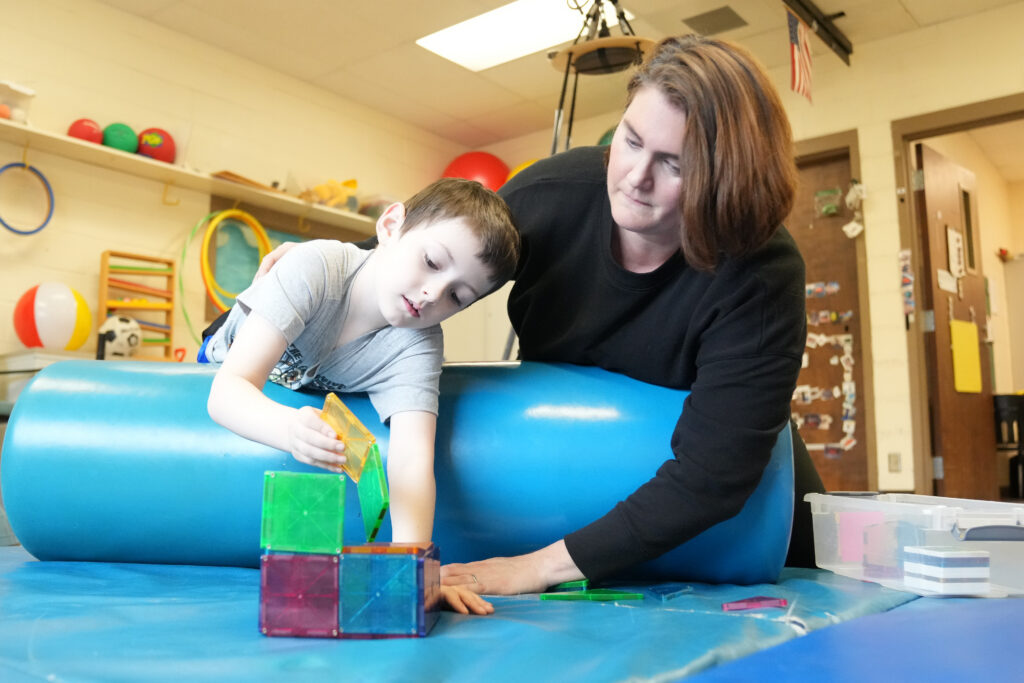 Educator working with a young student