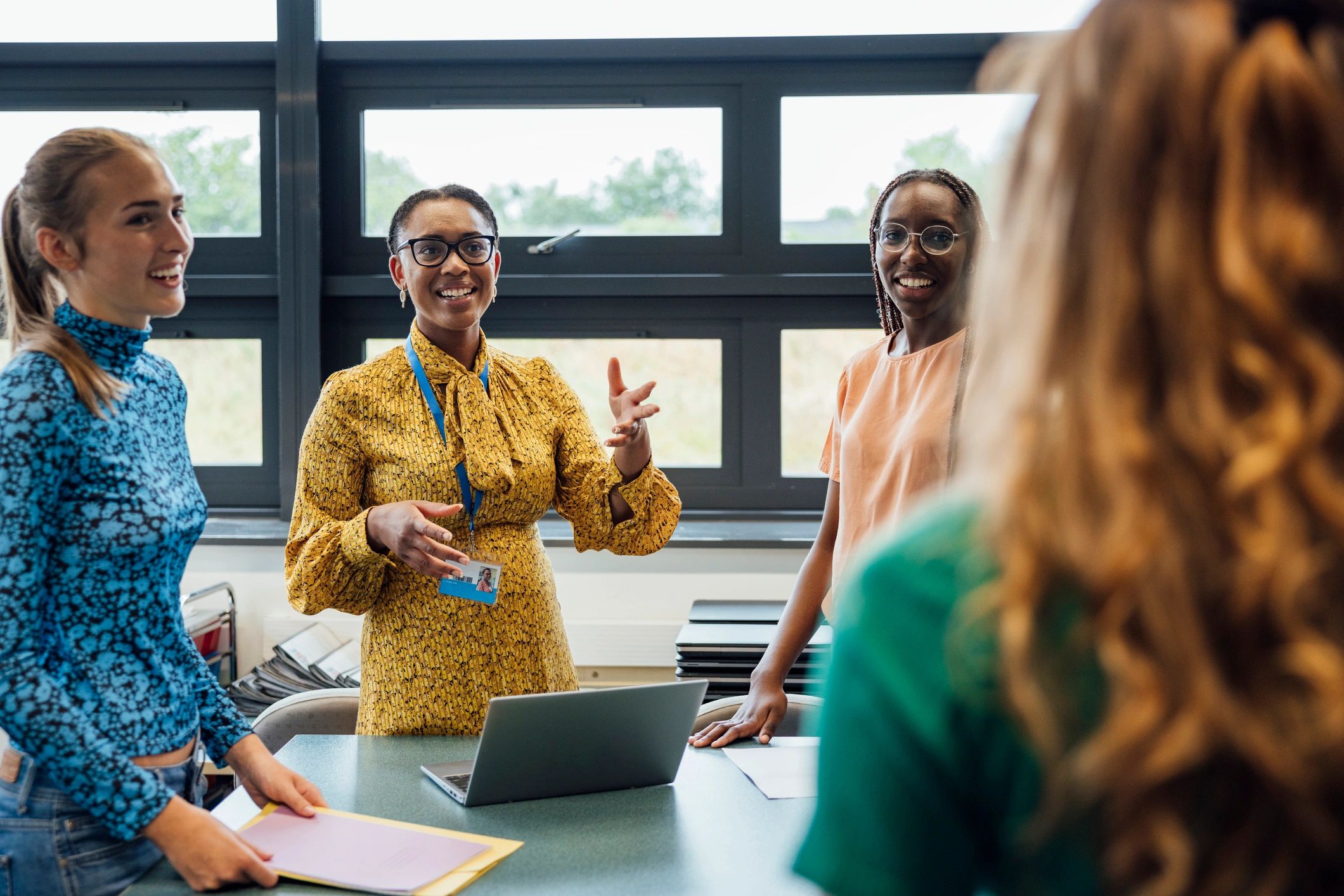 Teacher talking with students in a classroom