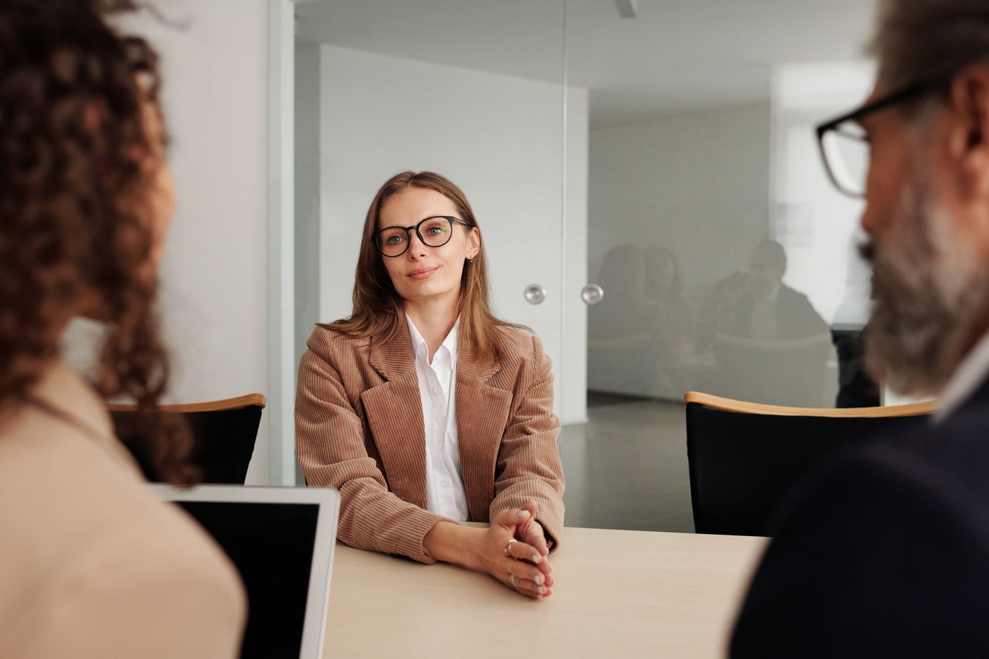 Candidate in a professional interview across the table from a panel