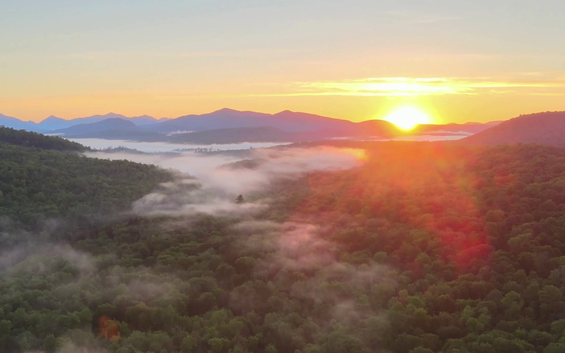 Sunrise over misty Adirondack mountains